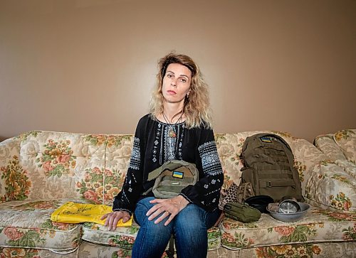 JESSICA LEE / WINNIPEG FREE PRESS

Widower Hanna Sidorchenko holds her deceased husband&#x2019;s belongings in her Winnipeg apartment June 7, 2023. In her left hand is a Ukrainian flag signed by 30 of her deceased husband&#x2019;s fellow soldiers. Of the thirty that signed the flag, only two are alive. Sidorchenko&#x2019;s husband died a few weeks ago fighting in the war in Ukraine. She went back to her home country try to bring his body to Canada but couldn&#x2019;t access where he died because it is a Russian controlled area.

Reporter: Kevin Rollason
