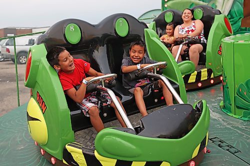 07062023
Cousins Walker Hanska and Waokiya Hanska of Birdtail Sioux Dakota Nation ride the Raptor Run ride on the midway during the opening night of the 2023 Manitoba Summer Fair at the Keystone Centre on a hot and stormy Wednesday night. (Tim Smith/The Brandon Sun)