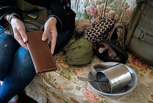 JESSICA LEE / WINNIPEG FREE PRESS

Widower Hanna Sidorchenko holds a wallet she gave to her now deceased husband in her Winnipeg apartment June 7, 2023. His other belongings can be seen in the photo. Sidorchenko&#x2019;s husband died a few weeks ago fighting in the war in Ukraine. She went back to her home country try to bring his body to Canada but couldn&#x2019;t access where he died because it is a Russian controlled area.

Reporter: Kevin Rollason