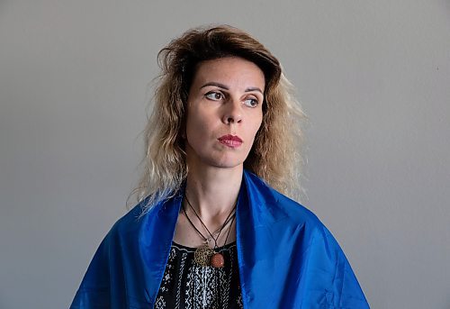 JESSICA LEE / WINNIPEG FREE PRESS

Widower Hanna Sidorchenko is draped in a Ukrainian flag signed by 30 of her deceased husband&#x2019;s fellow soldiers, in her Winnipeg apartment June 7, 2023. Of the thirty soldiers who signed the flag only two are alive. Sidorchenko&#x2019;s husband died a few weeks ago fighting in the war in Ukraine. She went back to her home country try to bring his body to Canada but couldn&#x2019;t access where he died because it is a Russian controlled area.

Reporter: Kevin Rollason