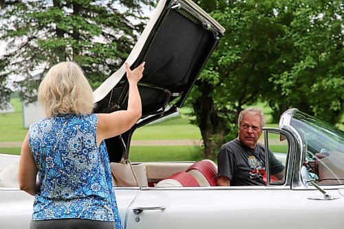 Elaine helps her husband Elwin Kettner put the top up on their 1959 Cadillac 2-door convertible, near their home northwest of Brandon on Thursday. (Michele McDougall/The Brandon Sun)  