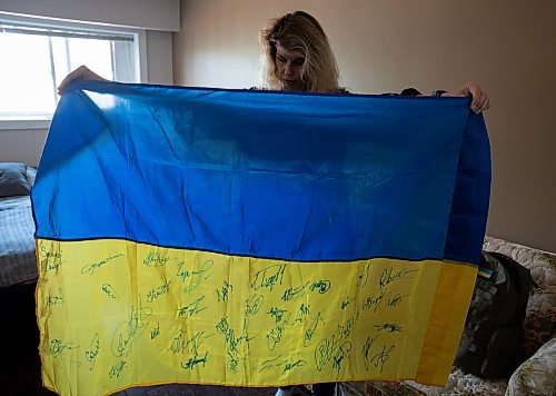JESSICA LEE / WINNIPEG FREE PRESS

Widower Hanna Sidorchenko holds a Ukrainian flag signed by 30 of her deceased husband’s fellow soldiers, in her Winnipeg apartment June 7, 2023. Only two are alive. Sidorchenko’s husband died a few weeks ago fighting in the war in Ukraine. She went back to her home country try to bring his body to Canada but couldn’t access where he died because it is a Russian controlled area.

Reporter: Kevin Rollason