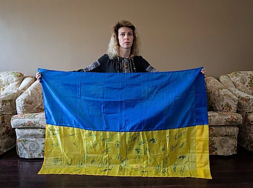 JESSICA LEE / WINNIPEG FREE PRESS

Widower Hanna Sidorchenko holds a Ukrainian flag signed by 30 of her deceased husband&#x2019;s fellow soldiers, in her Winnipeg apartment June 7, 2023. Only two are alive. Sidorchenko&#x2019;s husband died a few weeks ago fighting in the war in Ukraine. She went back to her home country try to bring his body to Canada but couldn&#x2019;t access where he died because it is a Russian controlled area.

Reporter: Kevin Rollason