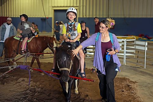 08062023
Ten-year-old Reece Makarich, who lives with non-verbal autism, rides a pony while his mom Britinay Wheeler walks beside him during Westman Disability Day at the Manitoba Summer Fair on Thursday afternoon. The event provided an opportunity for individuals with physical and/or intellectual disabilities and their families and caregivers to enjoy the fair for free without the usual crowds.
(Tim Smith/The Brandon Sun)