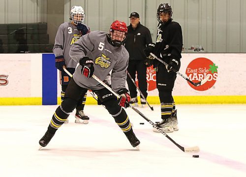 Jack Swaenepoel (5) of Souris makes a pass during a drill at Brandon Wheat Kings prospects camp under the watchful eye of Emerson Clark (3) and Maddox Gandha (12) and head coach Marty Murray at J&amp;G Homes Arena on May 26. (Perry Bergson/The Brandon Sun)