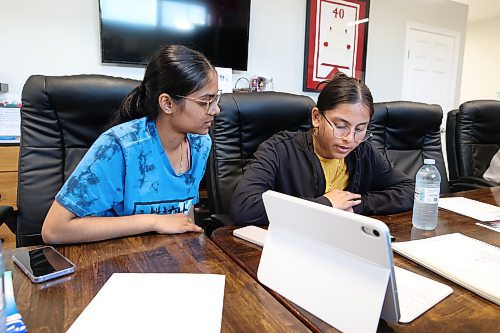 Crocus Plains Regional Secondary School students Archi Patel and Priya Parikh help seniors learn how to use their computers and smartphones at Seniors For Seniors on Park Avenue East. (Tim Smith/The Brandon Sun)