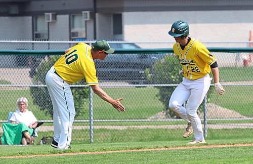 Boissevain-Wawanesa Broncos head coach Corey Billaney gives Mason De Ruyck a low five after the Grade 12 student homered during the Prairie West High School Baseball League championship game against the Vincent Massey Vikings at Andrews Field on Friday afternoon. Boissevain won 11-1 to win defend their title. (Perry Bergson/The Brandon Sun)