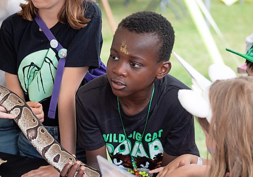 Mike Thiessen / Winnipeg Free Press 
Isi Isafiade holding a snake at the Prairie Exotics booth at the Winnipeg International Children&#x2019;s Festival, or Kidsfest. Put on by the Winnipeg Foundation, Kidsfest seeks to provide outstanding performances and informational interactive activities to children and families from diverse communities. 230609 &#x2013; Friday, June 9, 2023