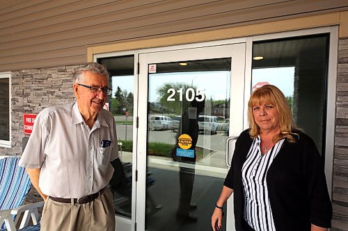 Harvey Douglas (left) and Melody Osudar (right) of the Westman Seniors' Housing Co-op stand outside the affordable housing complex the co-op operates on Brandon Avenue. They say increasing assessed property values for the co-op's two buildings are driving property taxes to the point of unaffordability. (Colin Slark/The Brandon Sun)