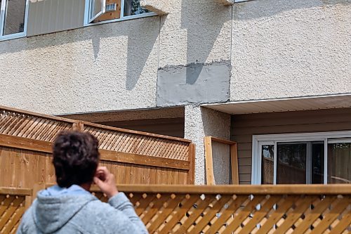 Eva Cameron of the Spruce Woods Housing Co-op in Brandon looks at a patched piece of wall on a row of townhouses at the complex. (Colin Slark/The Brandon Sun)