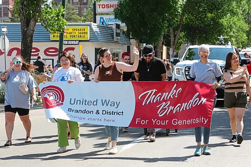 Local members of the United Way wave to the crowd during the opening leg of this year's Travellers' Days Parade. (Kyle Darbyson/The Brandon Sun)