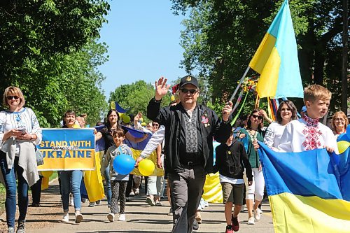 Members of Westman's Ukrainian community came out in droves for this year's Travellers' Day Parade, with some of them holding signs to show solidarity with those living through the ongoing war in their mother country. (Kyle Darbyson/The Brandon Sun)