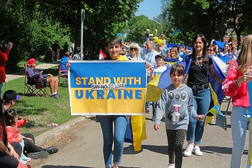 Members of Westman's Ukrainian community came out in droves for this year's Travellers' Day Parade, with some of them holding signs to show solidarity with those living through the ongoing war in their mother country. (Kyle Darbyson/The Brandon Sun)