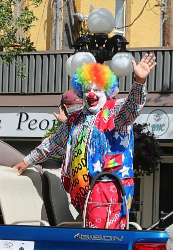 Doodles the Clown, a.k.a. Shane Faberman, waves to the crowd during this year's Travellers' Day Parade in downtown Brandon. (Kyle Darbyson/The Brandon Sun)