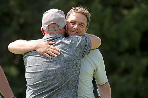 Jay Thiesen, right, hugs his dad, Ron, after winning his third Grey Owl golf tournament title. (Thomas Friesen/The Brandon Sun)