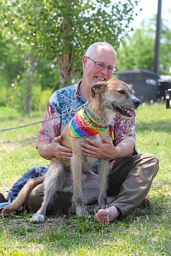 Brandon resident Gavin Chester gets acquainted with a new friend during the kick-off event for this year’s Brandon Pride Week. (Kyle Darbyson/The Brandon Sun)