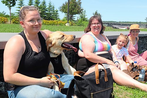 Trista Hayward, Aurora Van-Eaton, Kenlee Van-Eaton and Michelle Davies celebrate the beginning of Brandon Pride Week with Huxley the mixed lab at the Riverbank Discovery Centre grounds on Sunday. (Kyle Darbyson/The Brandon Sun)