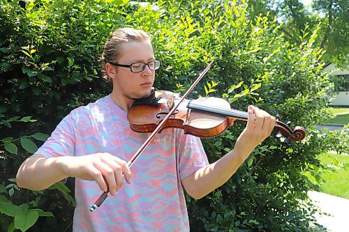 Vincent Massey High School student Jesse Gregory plays his violin outside his downtown Brandon residence on Sunday afternoon. Gregory took part in the 46th International Old-Time Fiddle Contest over the weekend and got second place. (Kyle Darbyson/The Brandon Sun)