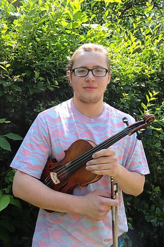Teen violinist Jesse Gregory poses for a photo outside his downtown Brandon residence on Sunday afternoon. Gregory took part in the 46th International Old-Time Fiddle Contest over the weekend and got second place. (Kyle Darbyson/The Brandon Sun)