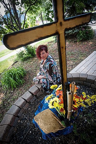 JOHN WOODS / WINNIPEG FREE PRESS
Lise Leveille, widow of Denis L&#x2019;Heureux who was killed when his motorcycle hit wet mud on a highway September 24/22, is photographed in a memorial area for Denis outside her Winnipeg home, Monday, June 12, 2023. Leveille is working to get MB govt to make it law that signs must be posted when construction/farm debris is on the road surface.

Reporter: kitching
