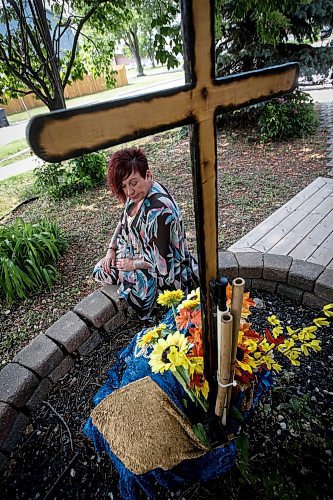 JOHN WOODS / WINNIPEG FREE PRESS
Lise Leveille, widow of Denis L&#x2019;Heureux who was killed when his motorcycle hit wet mud on a highway September 24/22, is photographed in a memorial area for Denis outside her Winnipeg home, Monday, June 12, 2023. Leveille is working to get MB govt to make it law that signs must be posted when construction/farm debris is on the road surface.

Reporter: kitching
