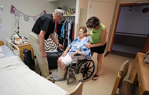 RUTH BONNEVILLE / WINNIPEG FREE PRESS

LOCAL - nursing home heat

Bernie Gray and  his wife, Lucy Grey, (92yrs), along with their daughter Dianne Grey-Wysocki, in Lucy's room at Golden Lakes Lodge where there is no AC.  

To help keep Lucy cool they lift her out of the chair in her room and move her into her wheelchair so she can be closer to the  hallway corridor.  

See story by Malak Abas 


Story: Like schools, some personal care homes are feeling the heat - the daughter of a woman at Golden Lakes Lodge says her 92-year-old mother is suffering and she's shocked there's not more funding from the province to get their HVAC system up to date:


Malak Abas 

June 12th,  2023