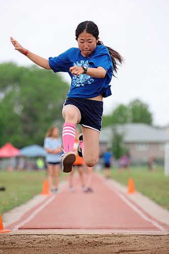 13062023
Yifan Zhao, a grade five student from Betty Gibson School, competes in the long jump event at the Brandon School Division City Wide Track Meet at the UCT Stadium on Tuesday. 
(Tim Smith/The Brandon Sun)