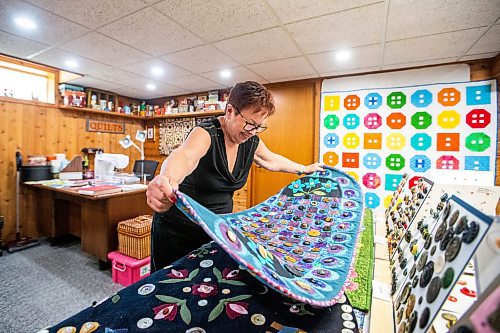 MIKAELA MACKENZIE / WINNIPEG FREE PRESS
Rita Wasney, who has been accumulating buttons for decades, delves into her home cache. She has worked buttons into many of her quilted pieces.
