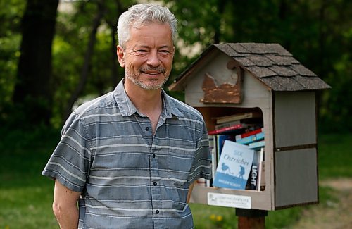 JOHN WOODS / WINNIPEG FREE PRESS
Philipp Schott, local author and veterinarian, is photographed with his new mystery novel, Six Ostriches, at his book exchange outside his home Tuesday, May 23, 2023. 

Reporter: sigurdson