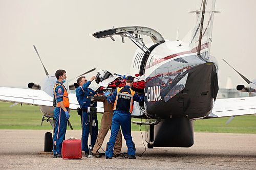 A critical care team loads a victim from Thursday's collision into a plane for transport to the Health Sciences Centre in Winnipeg at the Brandon Municipal Airport on Thursday afternoon. (Photos by Tim Smith/The Brandon Sun)