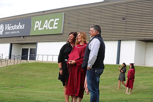 Agribusiness student Reegan Frey poses for a photo with some family friends outside of the Keystone Centre following Assiniboine Community College's Friday morning graduation ceremony in Brandon. (Kyle Darbyson/The Brandon Sun) 