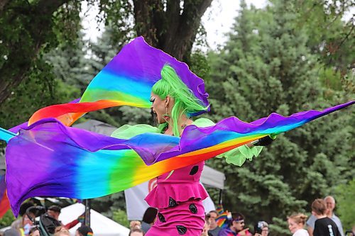 Local drag performer Flora Hex dual wields rainbow flags while lip syncing to Kelly Rowland's "When Love Takes Over" at Rideau Park Saturday afternoon. (Kyle Darbyson/The Brandon Sun) 