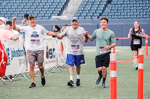 JOHN WOODS / WINNIPEG FREE PRESS
Rick Bochinski,55, with his dad Garry, 81, and son Michael, 25, finish their run together in the 45th Manitoba Marathon in Winnipeg, Sunday, June 18, 2023. 

Reporter: Donald