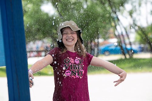 BROOK JONES / WINNIPEG FREE PRESS
Eight-year-old Khloe Zerr keeps cool at the Red River Ex in Winnipeg, Man., Sunday, June 18, 2023 by standing in the spray pad area. The Red River Ex runs June 16 to 25. 