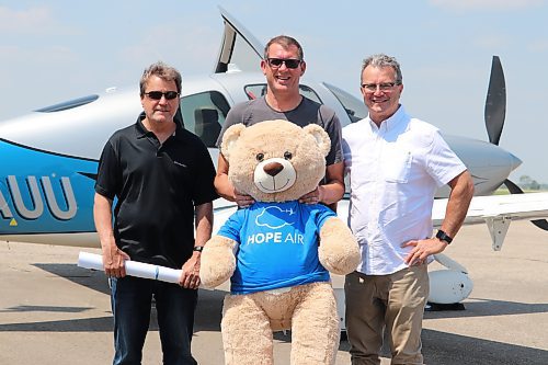 Roy McNair, Rupert Robin and David McNair pose for a group photo in front of a Cirrus SR22 after landing at the Brandon Flight Centre Sunday afternoon. The trio are part of a 10-aircraft fleet that is flying across the Prairies to raise money and awareness for the national charity Hope Air. (Kyle Darbyson/The Brandon Sun)