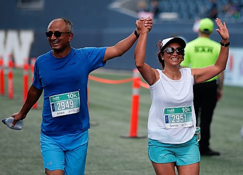 JOHN WOODS / WINNIPEG FREE PRESS
Aloke, left, and Smrita Rajvhandary celebrate as they cross the finish in the 45th Manitoba Marathon in Winnipeg, Sunday, June 18, 2023. 

Reporter: Donald