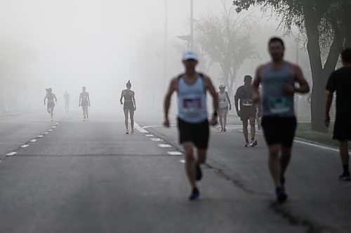 JOHN WOODS / WINNIPEG FREE PRESS
Runners warm up in the fog prior to the 45th Manitoba Marathon in Winnipeg, Sunday, June 18, 2023. 

Reporter: Donald