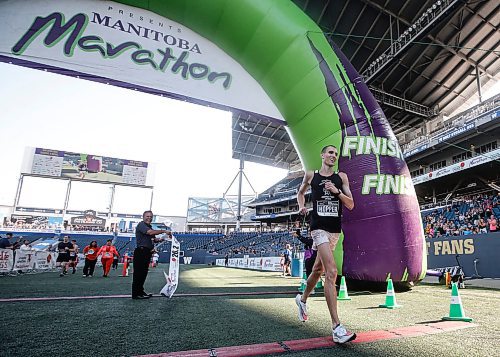 JOHN WOODS / WINNIPEG FREE PRESS
Roger Hopper crosses the line to finish first in the 45th Manitoba Marathon in Winnipeg, Sunday, June 18, 2023. 

Reporter: Donald