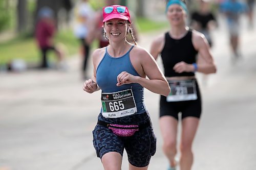 BROOK JONES / WINNIPEG FREE PRESS
Winnipeg resident Katie Zwingerman smiles as she runs down Assiniboine Avenue, while competing in the full marathon at the Manitoba Marathon in Winnipeg, Man., Sunday, June 18, 2023.