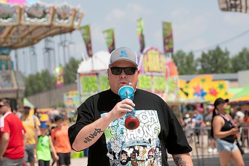 BROOK JONES / WINNIPEG FREE PRESS
Winnipeg resident Dave Carroll enjoys a cherry slushie while attending the Red River Ex in Winnipeg, Man., Sunday, June 18, 2023. The Red River Ex runs June 16, to 25.