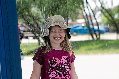 BROOK JONES / WINNIPEG FREE PRESS
Eight-year-old Khloe Zerr keeps cool at the Red River Ex in Winnipeg, Man., Sunday, June 18, 2023 by standing in the spray pad area. The Red River Ex runs June 16 to 25. 