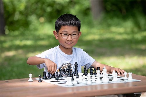 BROOK JONES / WINNIPEG FREE PRESS
Eight-year-old Aiden Ling, who attends Linden Christian School, practices his chess game, while visiting King's Park with his mother, Joan Wang, on the afternoon of Sunday, June 18, 2023. The Grade 2 student recently placed third in his age category at the Chess'n Math Canadian Chess Challenge in Montreal, Que., in May. He will be competing at the Canadian Youth Chess Challenge in Calgary, Alta., from July 19 to 22. 