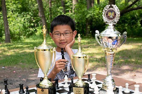 BROOK JONES / WINNIPEG FREE PRESS
Eight-year-old Aiden Ling, who attends Linden Christian School, holds a King chess piece while practicing his chesse game at King's Park in Winnipeg, Man., Sunday, June 18, 2023. He won a third place trophy for his age category at the Chess'n Math Canadian Chess Challenge in Montreal, Que., in May. He also earned first place trophies while in Grade 1 and Grade 2 at the Manitoba Provincial Chess Championships. The Grade 2 student will be competing at the Canadian Youth Chess Challenge in Calgary, Alta., from July 19 to 22. 