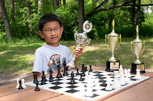 BROOK JONES / WINNIPEG FREE PRESS
Eight-year-old Aiden Ling, who attends Linden Christian School, practices his chess game, while he holds up a third place trophy he earned for his age category at the Chess'n Math Canadian Chess Challenge in Montreal, Que., in May. He will be competing at the Canadian Youth Chess Challenge in Calgary, Alta., from July 19 to 22. The Grade 2 student also earned first place trophies, while in Grade 1 and Grade 2 at the Manitoba Provincial Chess Championships. 