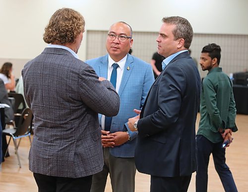 Jon Reyes, Manitoba's Minister of Labour and Immigration, (in centre), talks with Jeff Fawcett, Mayor of Brandon, along with Patrick Mackenzie, (on right), CEO of Immigrant Employment Council of B.C. (IECBC) during the inaugural Workforce Development Summit hosted by the Rural Manitoba Immigrant Employment Council (RMIEC), which is an initiative of Westman Immigrant Services, at the Keystone Centre on Monday. (Michele McDougall/The Brandon Sun)
