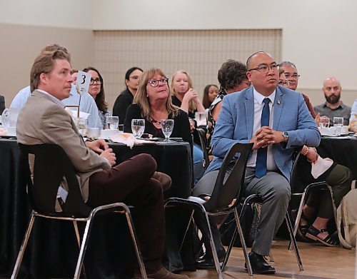 Jon Reyes, Manitoba's minister of labour and immigration (right), listens to the keynote address at the inaugural Workforce Development Summit at the Keystone Centre on Monday. (Michele McDougall/The Brandon Sun)