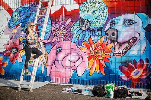 Mike Deal / Winnipeg Free Press
Rachel Lancaster works on a mural on the side of WinRose Animal Hospital on St. Anne's at Bishop Grandin Boulevard, Monday morning.
Rachel Lancaster, a mural artist who, for about 10 years now, has been transforming bedroom walls, garage doors and sides of businesses into works of art. No project is too big or too small - and what she comes up with is up to the imagination of those hiring her to do their bidding.
230619 - Monday, June 19, 2023.