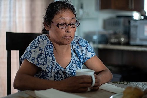 Daniel Crump / Winnipeg Free Press. Vivian Caron, of Lake St. Martin First Nation, sits at her mothers dining room table as she talks about her son Evan Caron. Evan was 33 when he was shot and killed by Winnipeg Police in 2017. June 17, 2023.