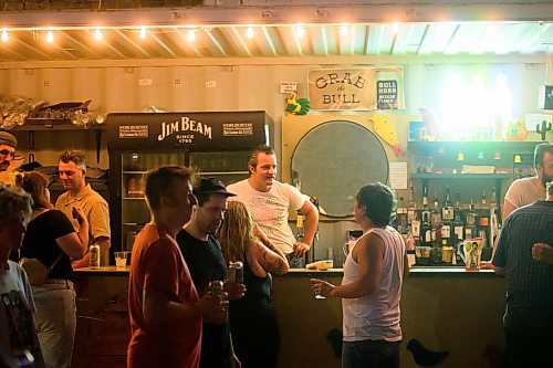 Mike Sudoma/Winnipeg Free Press
A bartender chats with patrons enjoying a midnight drink at Blue Note Park Tuesday 
June 20, 2023