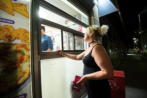 Mike Sudoma/Winnipeg Free Press
Patron Megan Kole puts in an order through the 24 hour service window at Vast Market. Kole is a regular, saying she frequently comes to the shop for late night snacks and groceries for her family.
June 20, 2023